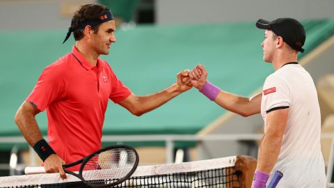Federer shakes hands with Koepfer of Germany after winning their match early on Sunday morning.