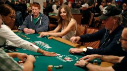 Maria Konnikova, center, competes during the first day of the World Series of Poker main event Monday, July 2, 2018, in Las Vegas. (AP Photo/John Locher)