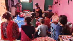 Devika teaches her younger siblings at home.