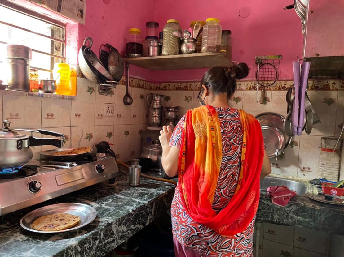 Devika's sister prepares food in the kitchen of their New Delhi home on June 2, 2021.