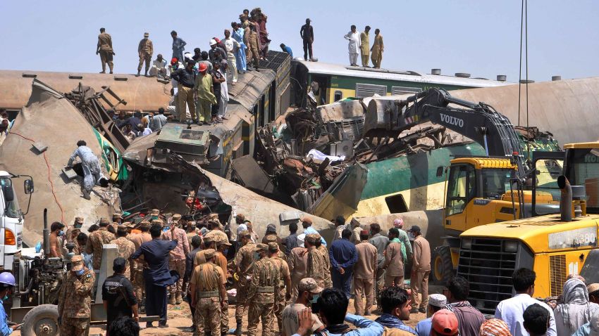 Soldiers and volunteers work at the site of a train collision in the Ghotki district in southern Pakistan, Monday, June 7, 2021. Two express trains collided in southern Pakistan early Monday, killing dozens of passengers, authorities said, as rescuers and villagers worked to pull injured people and more bodies from the wreckage. (AP Photo/Waleed Saddique)