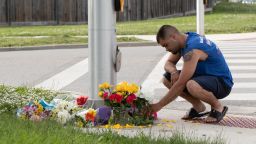 A man brings flowers and pays his respects at the scene where a man driving a pickup truck struck and killed four members of a Muslim family in London, Ontario, Canada on June 7, 2021. - A man driving a pick-up truck slammed into and killed four members of a Muslim family in the south of Canada's Ontario province, in what police said Monday was a "premeditated" attack.A 20-year-old suspect wearing a vest "like body armor" fled the scene after the attack on Sunday evening, and was arrested at a mall seven kilometers (four miles) from the intersection in London, Ontario where it happened, said Detective Superintendent Paul Waight. (Photo by Nicole OSBORNE / AFP) (Photo by NICOLE OSBORNE/AFP via Getty Images)