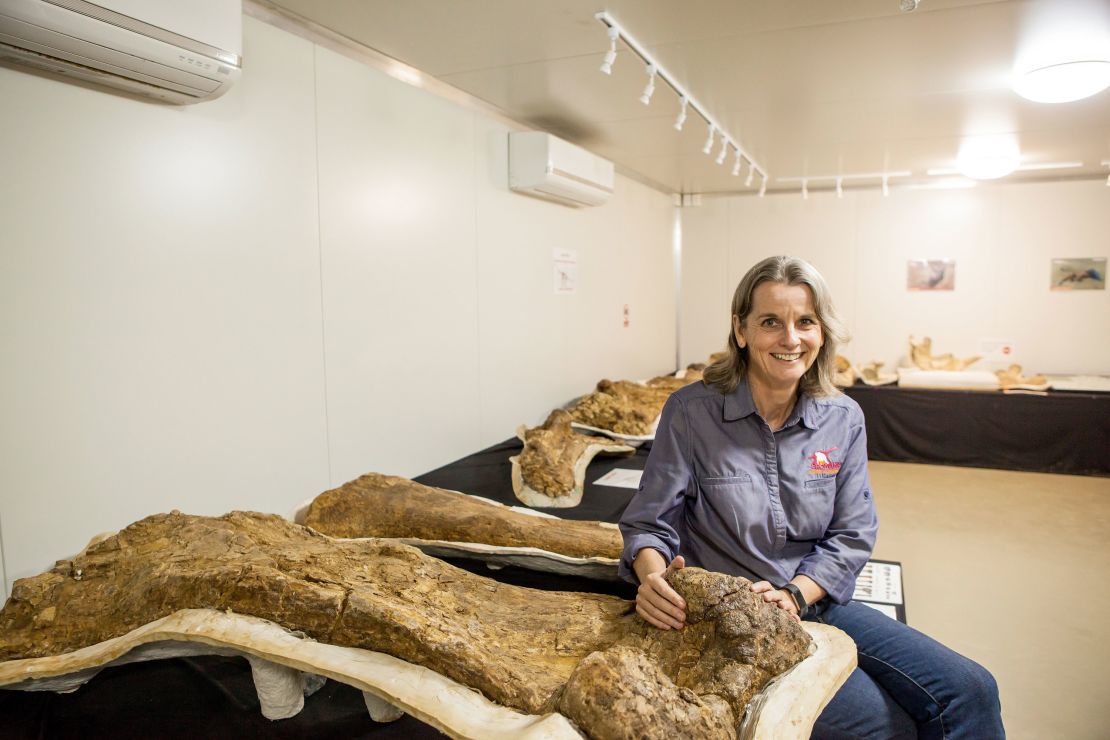 Robyn Mackenzie, co-founder of the Eromanga Natural History Museum, next to the fossilized dinosaur skeleton.