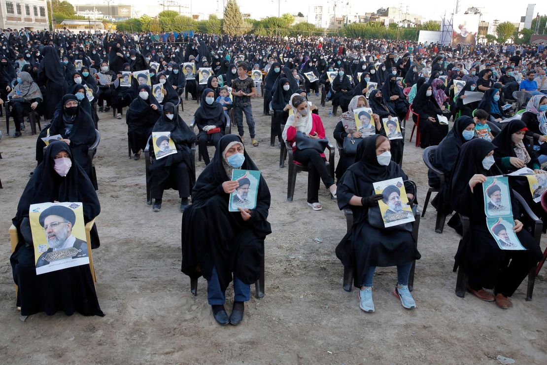 Women supporters of Raisi hold up his posters during a campaign rally in Eslamshahr, outside Tehran, on June 6.
