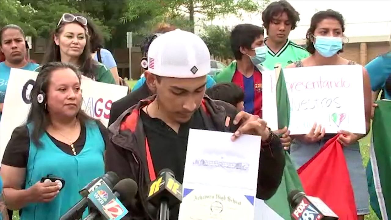 Lopez holding his diploma after receiving it on Monday.