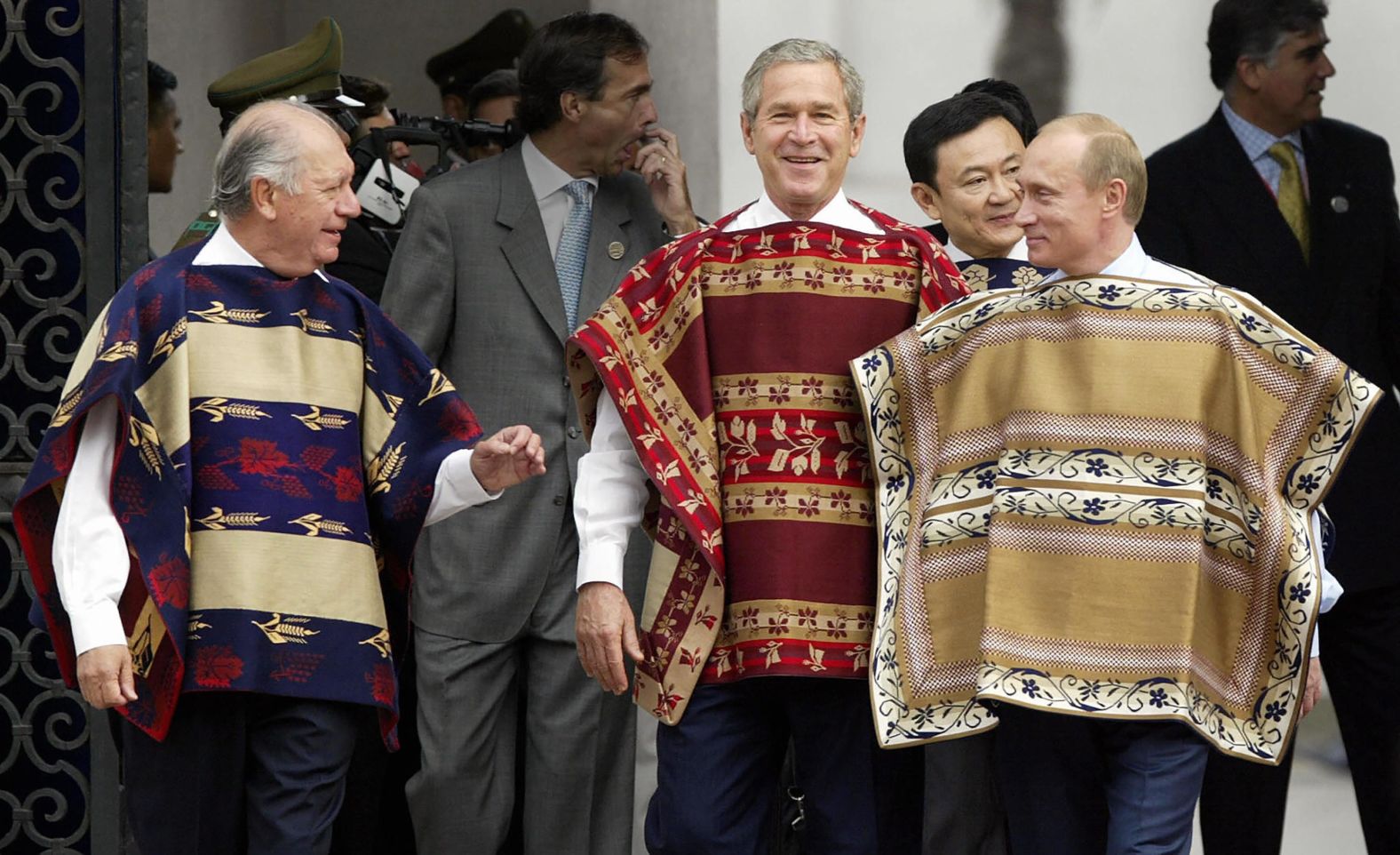 Bush and Putin, wearing traditional Chilean ponchos, walk with Chilean President Ricardo Lagos, left, at the APEC Summit in Santiago, Chile, in 2004.