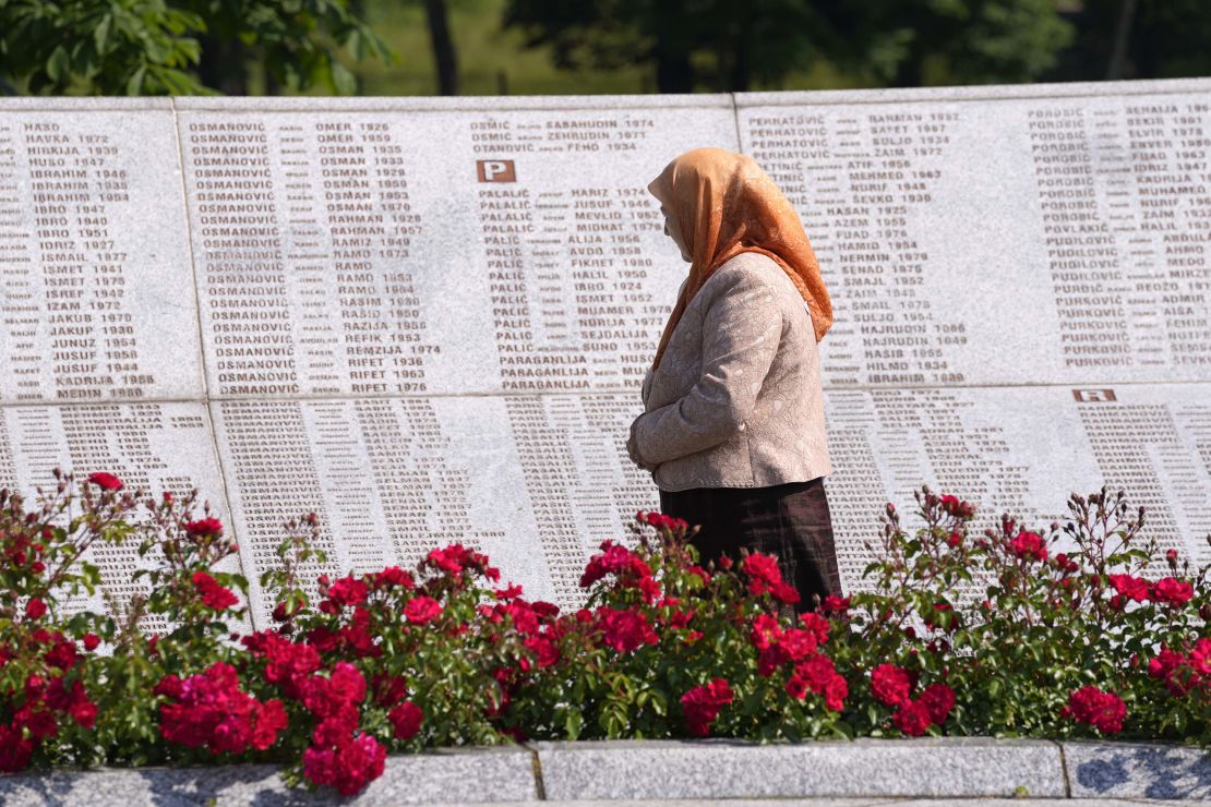 A woman observes the names of victims of the Srebrenica massacre, at the memorial cemetery in Potocari, near Srebrenica, eastern Bosnia, Tuesday, June 8.