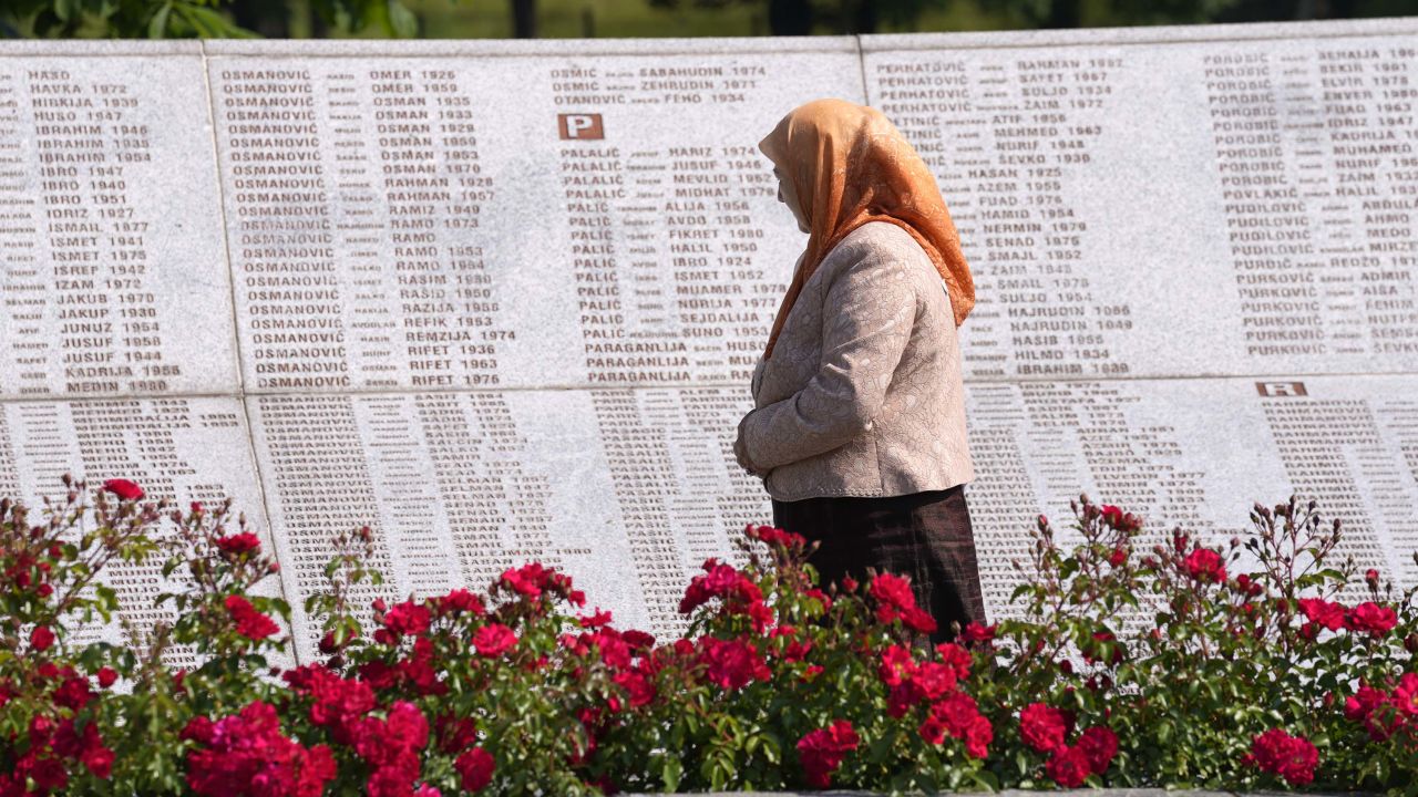 A woman observes the names of victims of the Srebrenica massacre, at the memorial cemetery in Potocari, near Srebrenica, eastern Bosnia, Tuesday, June 8.