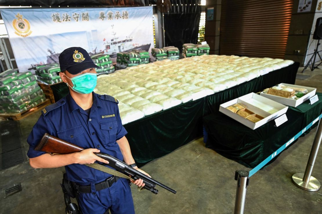 An armed customs officer guards a record seizure of over 500 kilograms of methamphetamine during a news conference in Hong Kong in November.