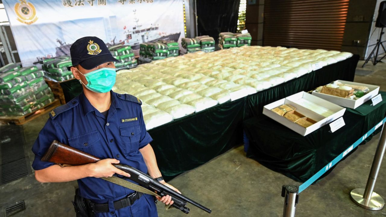 An armed customs officer guards a record seizure of over 500 kilograms of methamphetamine during a news conference in Hong Kong in November.