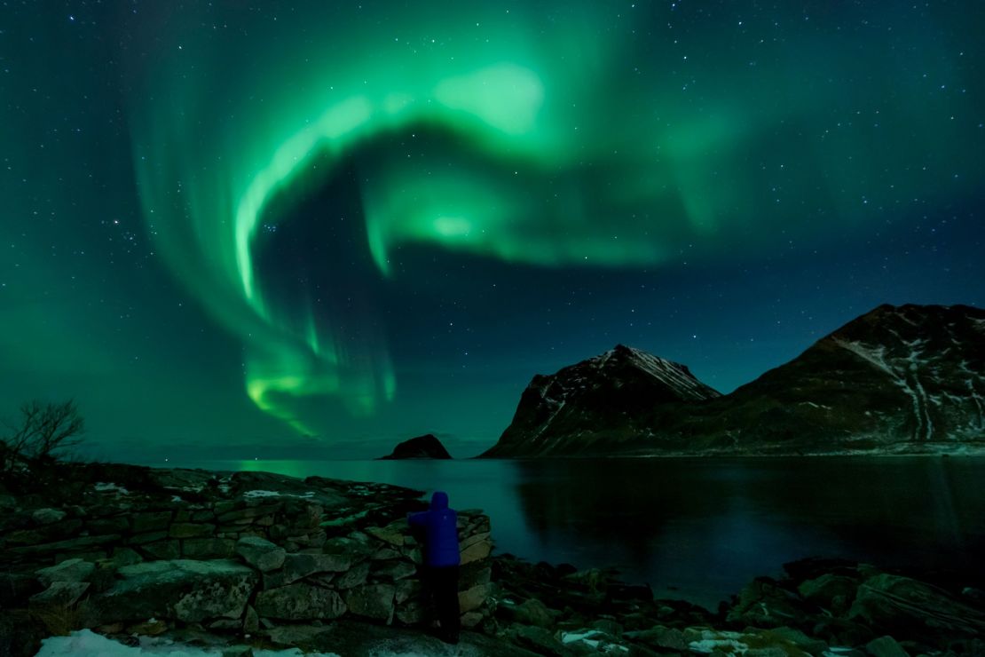 A person watches the northern lights on March 9, 2018, in Utakleiv, northern Norway.