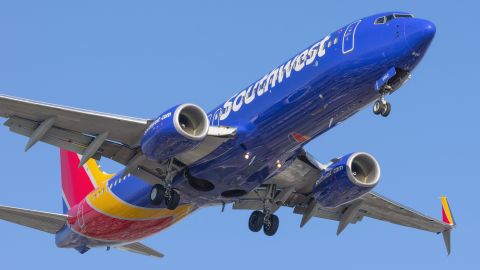 underscored southwest airlines plane at angle from underneath