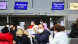 Travelers wearing protective face masks at the Ryanair Holdings Plc check-in desks at Frankfurt Airport in Frankfurt, Germany, on Tuesday, June 8, 2021. Ryanair will tomorrow appeal the European Commission's decision in April 2020 to approve Covid-19-related aid in the form of a 550 million-euro German State-guaranteed loan to charter airline Condor. Photographer: Alex Kraus/Bloomberg via Getty Images