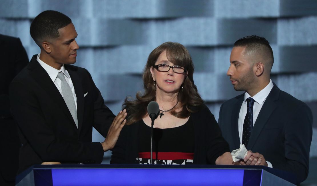 Christine Leinonen, mother of Christopher Andrew Leinonen, is comforted by Brandon Wolf (left) and Jose Arriagada (right), survivors of the Pulse massacre.