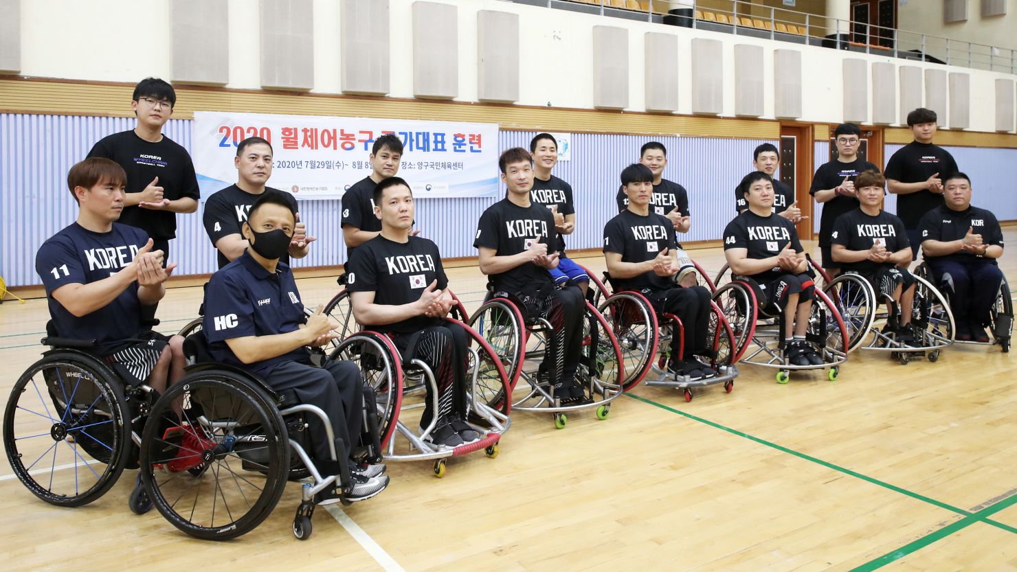 South Korean wheelchair basketball team and Han Sa-hyun (far left, front row) expressing gratitude to medical staff in sign language during the Covid-19 pandemic as they gathered for Paralympics training.
