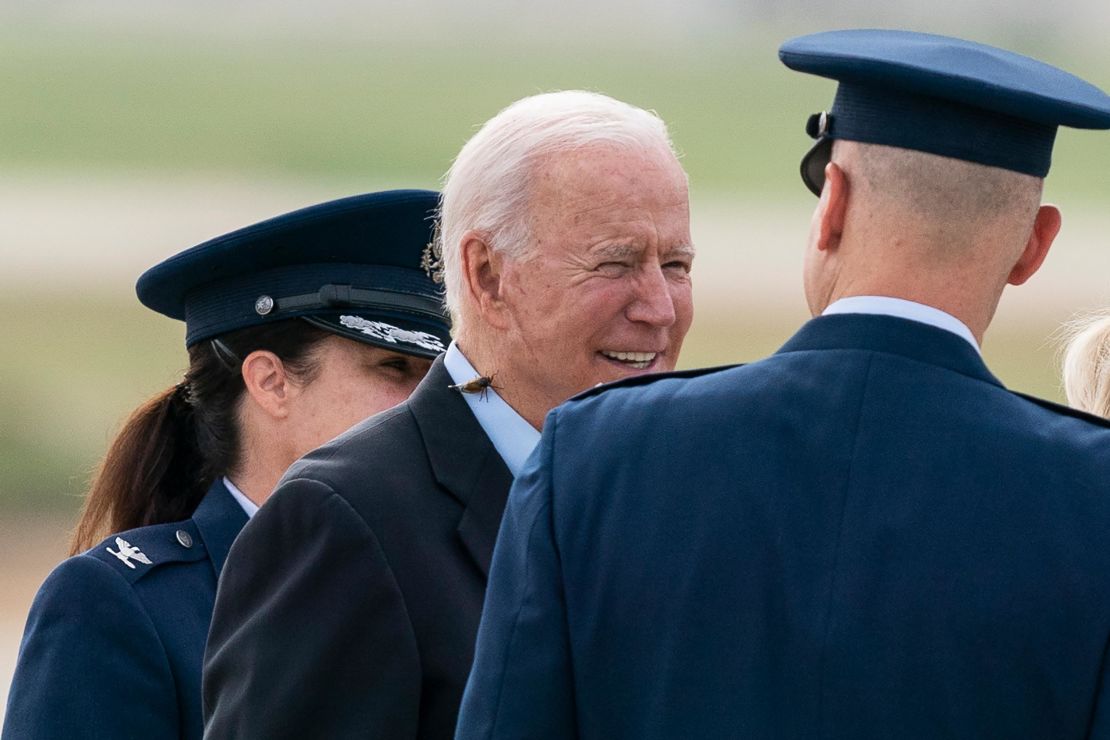 President Joe Biden, with a Brood X cicada on his back, walks out to board Air Force One, on Wednesday, June 9, at Andrews Air Force Base.