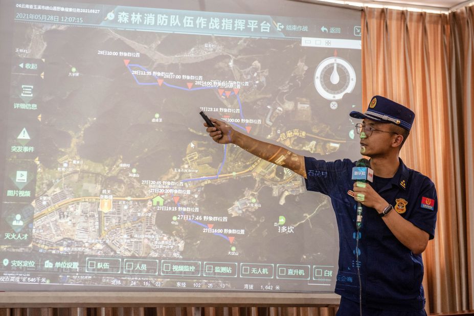A government official shows the migration route of the elephants in Eshan County on May 28.