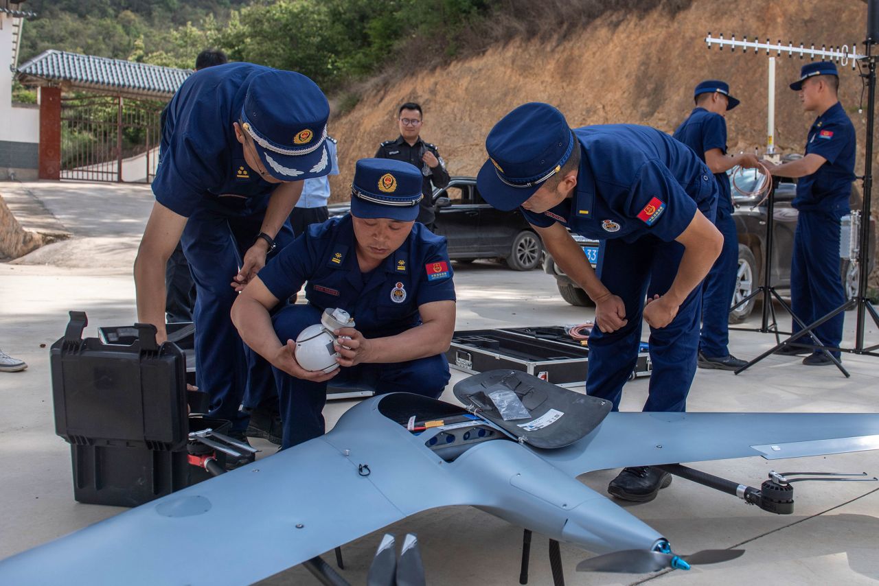 Officials prepare a drone to monitor the elephant herd in Eshan County of Yunnan province on May 29.