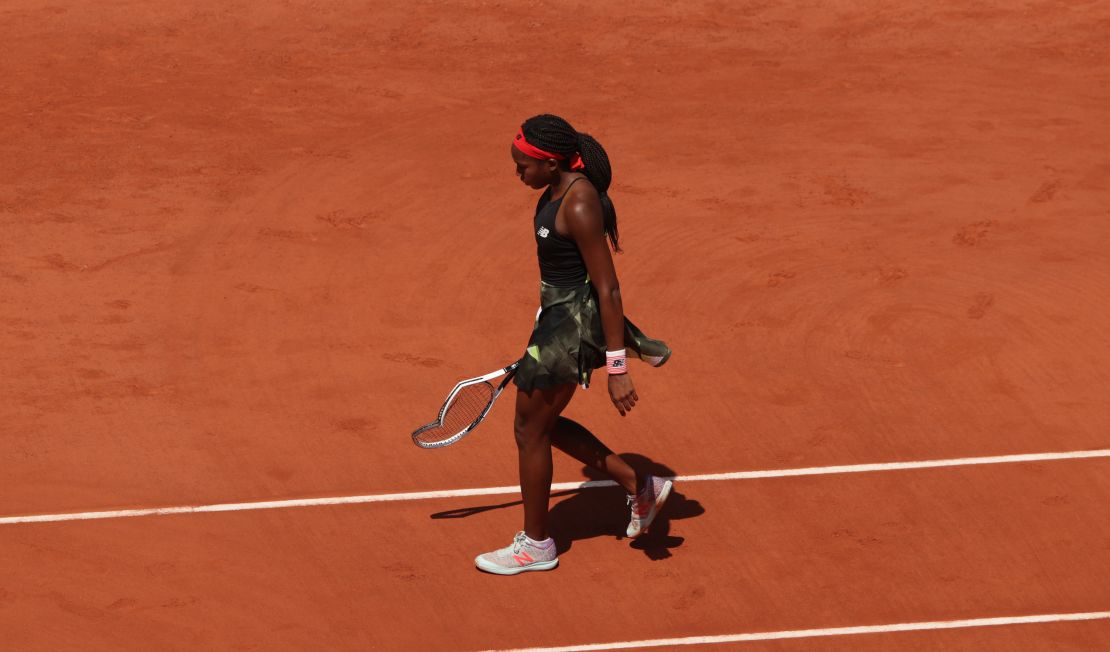 Gauff walks to retrieve a new racquet after breaking her first one during her match against  Krejcikova.