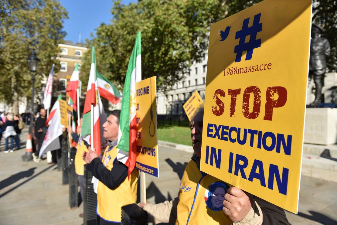 People protest against Iran's death penalty opposite Downing Street as a march to demand a people's vote against Brexit passes by on October 2018 in London, England. 