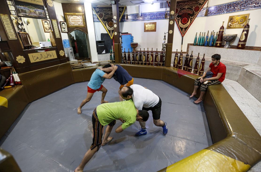 Iranians wrestle during a workout session at the traditional Shir Afkan "zurkhaneh" (House of Strength) gymnasium in the capital Tehran in February 2018.