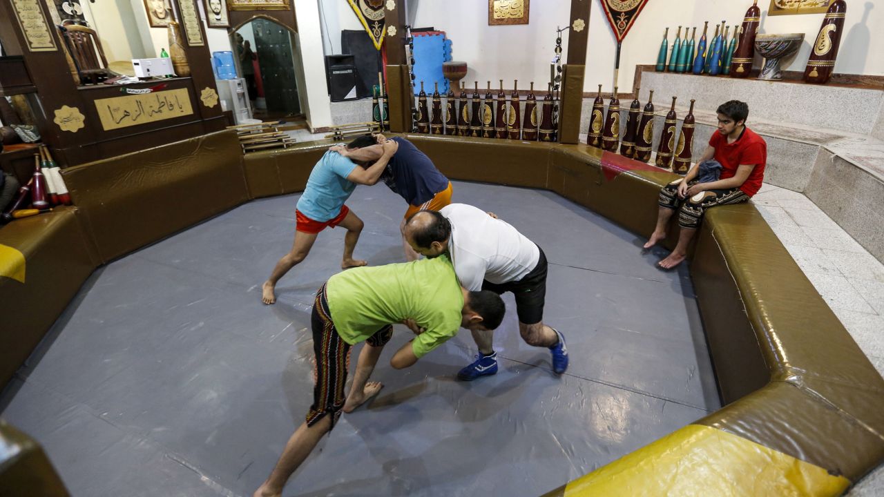 Iranians wrestle during a workout session at the traditional Shir Afkan "zurkhaneh" (House of Strength) gymnasium in the capital Tehran in February 2018.