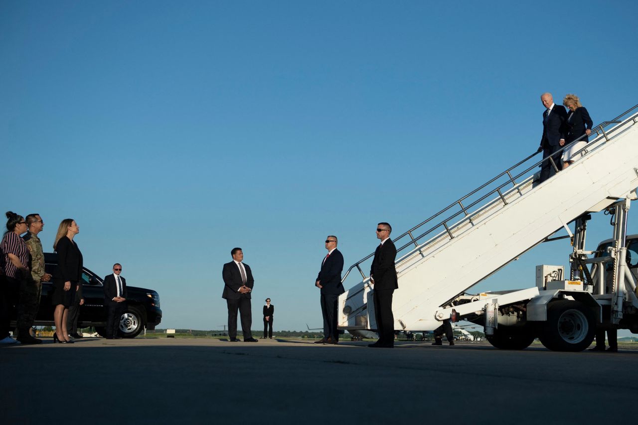 The Bidens walk off Air Force One after arriving in England.
