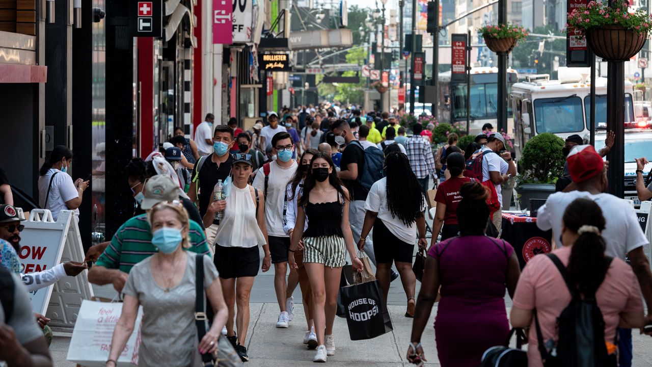 People walk through a shopping area in Manhattan on June 7, 2021 in New York City.