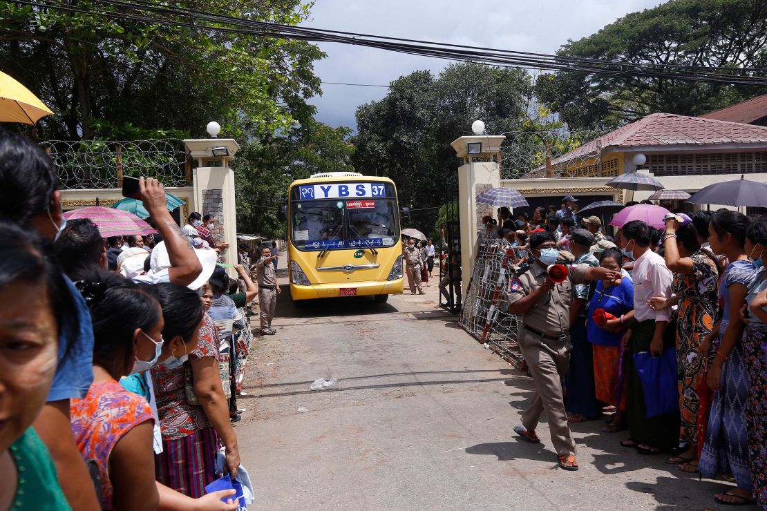 Relatives wait for a bus carrying prisoners to be released outside Insein Prison in Yangon on April 17.