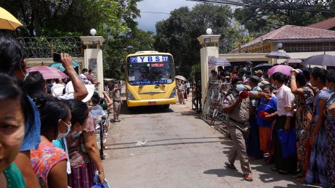 Relatives wait for a bus carrying prisoners to be released outside Insein Prison in Yangon on April 17.