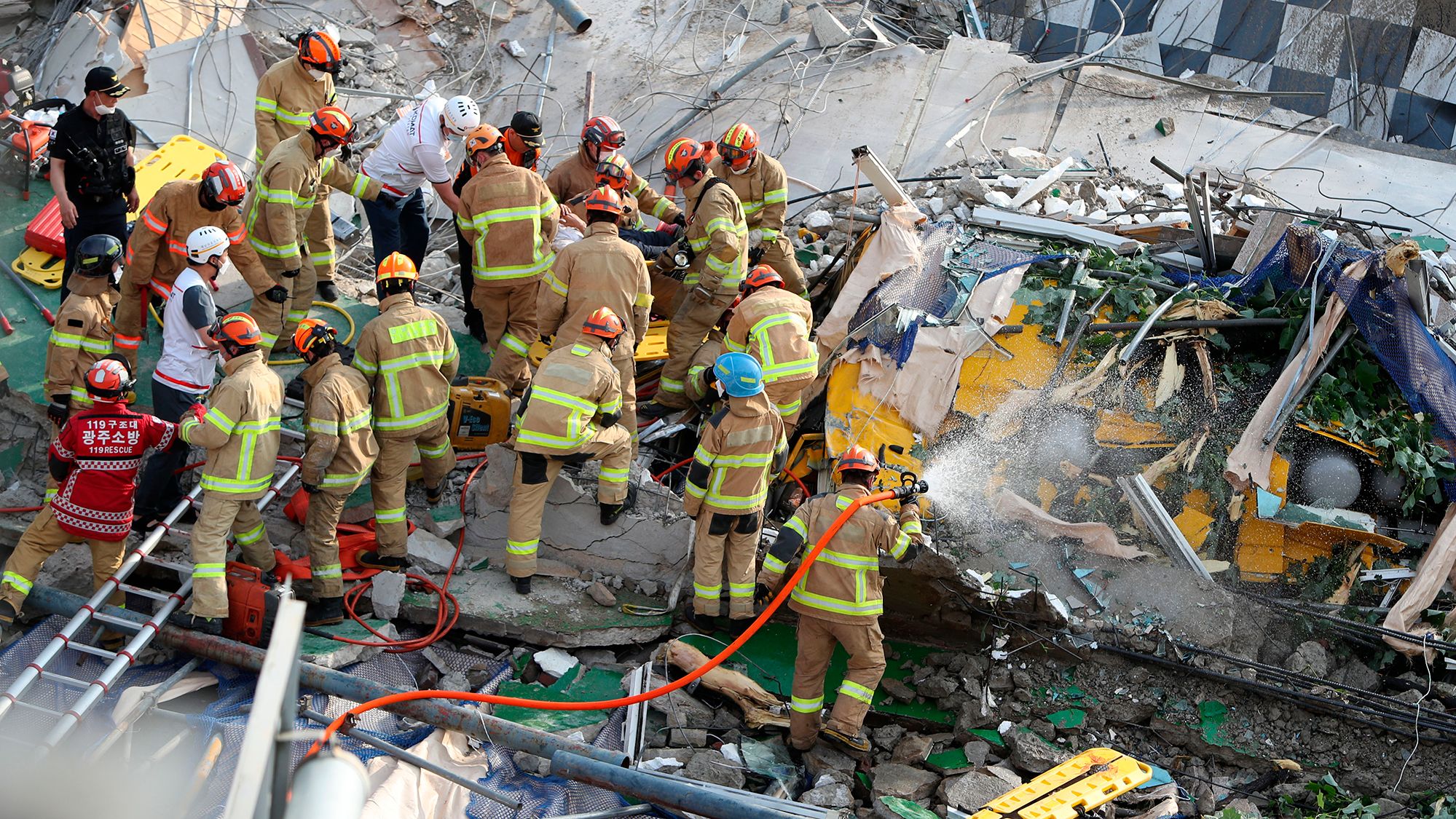 Firefighters search for survivors from a collapsed building in Gwangju, South Korea, on June 9.