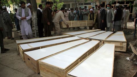 Coffins of victims from the attack in Afghanistan's Baghlan province are placed on the ground at a hospital on June 9.