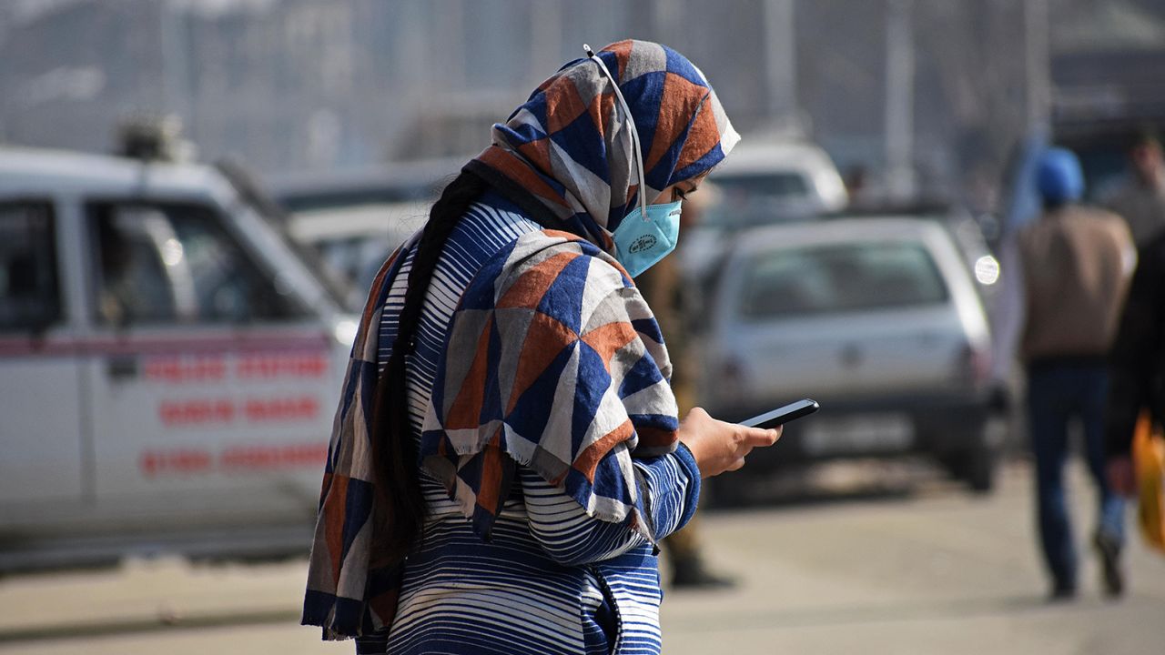 A woman using her cellphone in Srinagar, India. Photo by Faisal Khan/Anadolu Agency via Getty Images