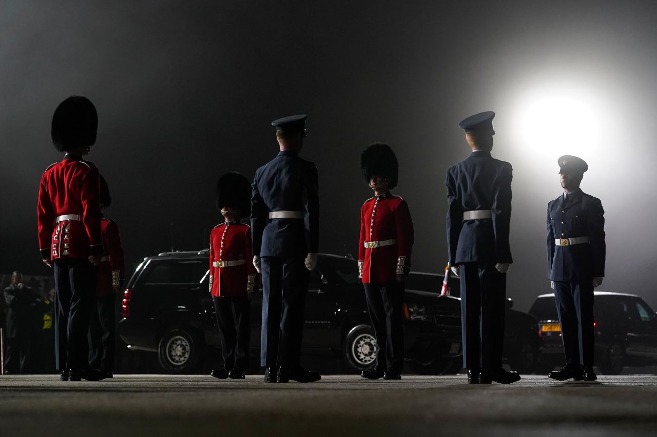 An honor guard stands on a foggy tarmac before the Bidens stepped off Air Force One in Newquay, England.