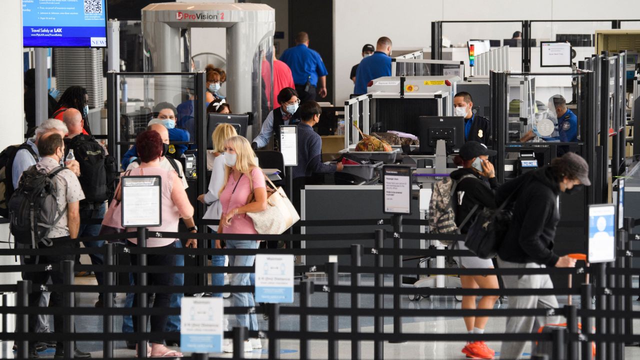 Travelers enter a new Transportation Security Administration (TSA) screening area during the opening of the Terminal 1 expansion at Los Angeles International Airport (LAX) on June 4, 2021 in Los Angeles, California. - - The terminal expansion is part of a $477.5 million infrastructure project to expand passenger capacity including security screening, baggage, and a future connection to the Automated People Mover (APM) train system. (Photo by Patrick T. FALLON / AFP) (Photo by PATRICK T. FALLON/AFP via Getty Images)