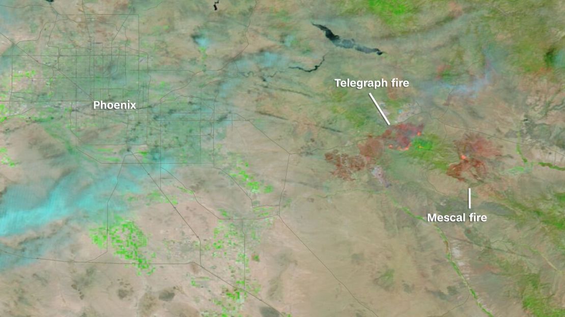 The extent of the burn area of the growing Telegraph and Mescal wildfires in Arizona can be seen on NASA satellites. This image uses what is called "false color," a combination of wavelengths different from what the human eye can see. It is most useful for distinguishing burn scars (in red) from naturally low vegetation (in green). The two fires combined have almost burned at least 155,000 acres, an area nearly half the size of Phoenix, which is seen in this image just west of the fires.
