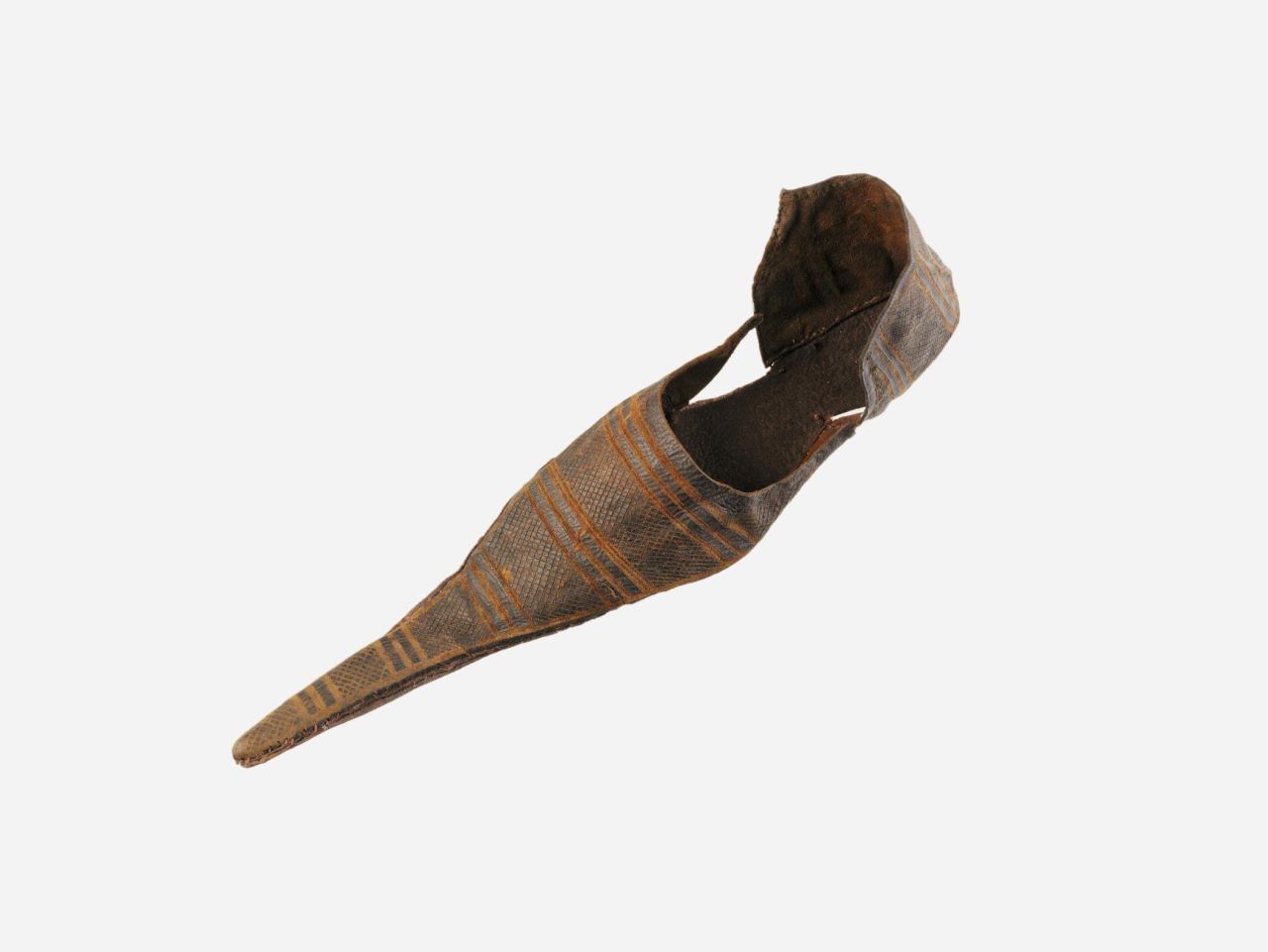 This pointed-toe medieval shoe is known as a poulaine. The artifact dates from the late 14th century and is on display at the Museum of London.