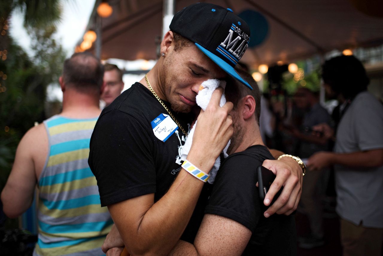 A pair embrace after exiting Parliament House, a gay bar and resort where people were gathering on June 12, 2016, in the wake of the mass shooting at the Pulse nightclub in Orlando, Florida.