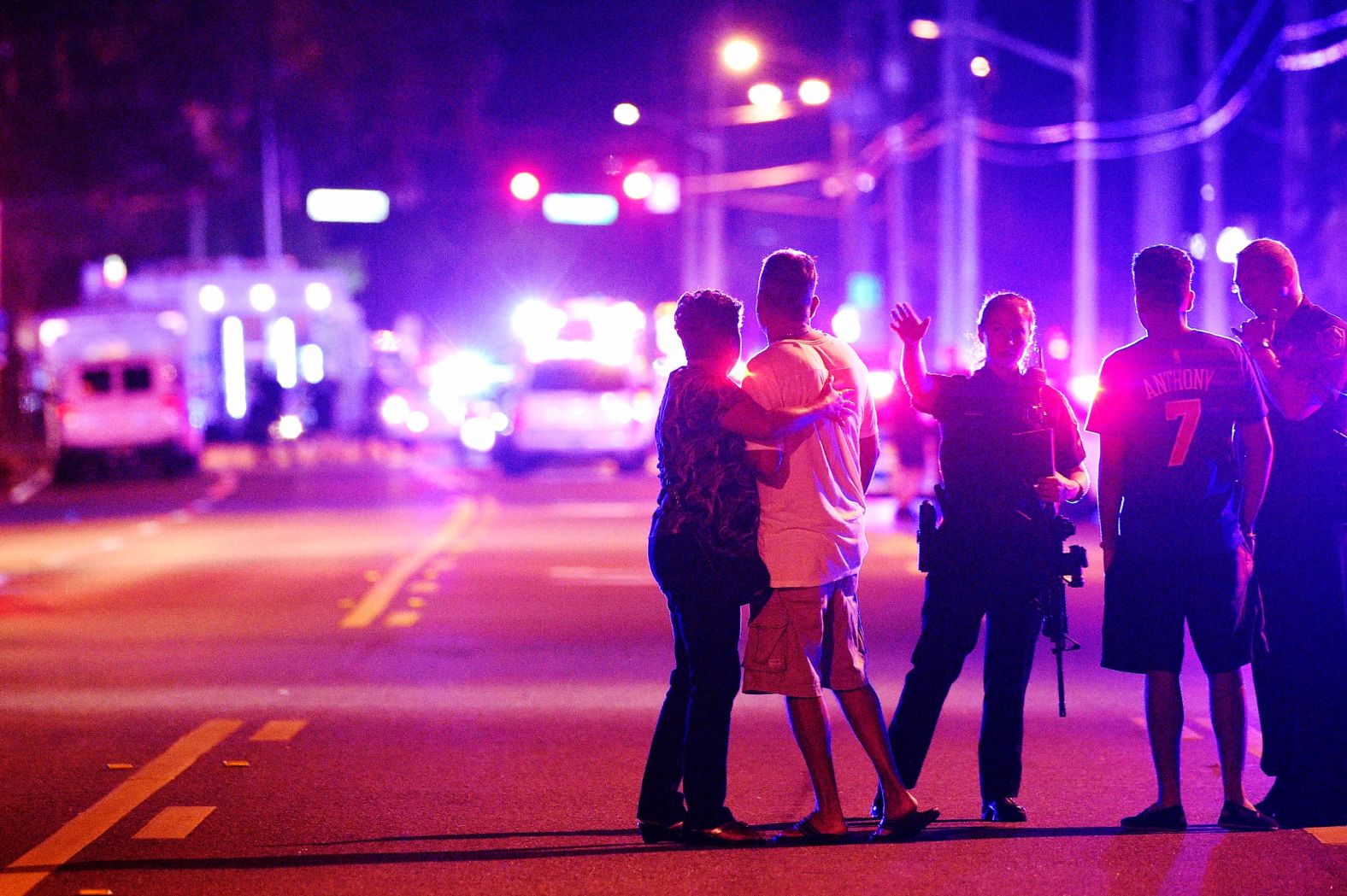 Orlando police officers direct friends and family away from the scene.