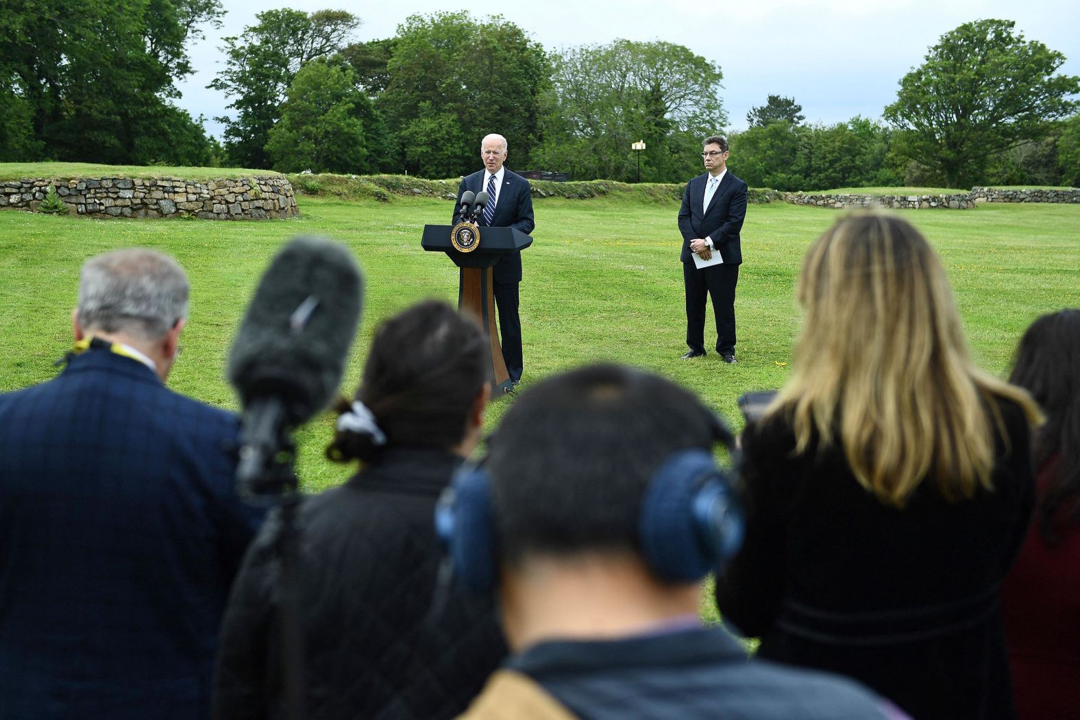 Biden delivers a speech about Covid-19 as Pfizer CEO Albert Bourla stands alongside him Thursday in St. Ives, England. Biden announced that the United States <a href="index.php?page=&url=https%3A%2F%2Fwww.cnn.com%2F2021%2F06%2F10%2Fpolitics%2Fjoe-biden-vaccine-us-leadership%2Findex.html" target="_blank">plans to donate 500 million doses of Pfizer's Covid-19 vaccine globally</a> as part of his efforts to reassert US leadership on the world stage.