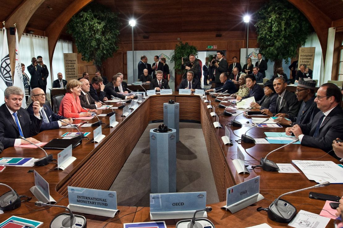 G7 leaders and outreach guests including Germany's Chancellor Angela Merkel (2-R) and United States President Barack Obama (2-L) attend a working session with at the summit of G7 nations at Schloss Elmau on June 8, 2015 near Garmisch-Partenkirchen, Germany. 