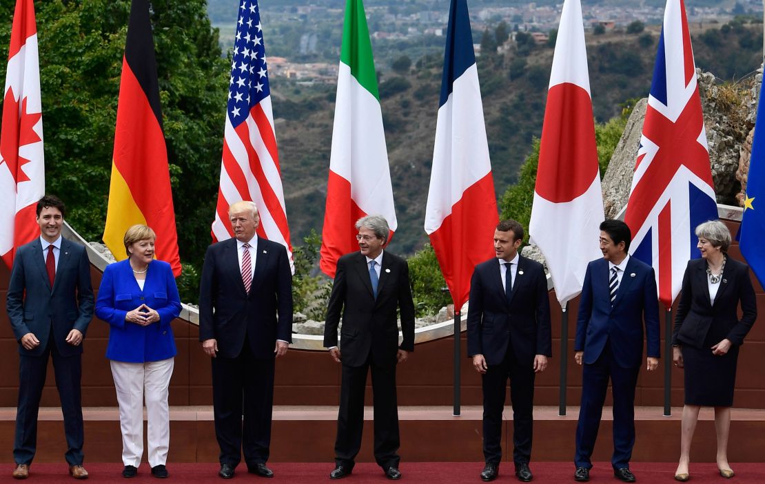Canadian Prime Minister Justin Trudeau, German Chancellor Angela Merkel, US President Donald Trump, Italian Prime Minister Paolo Gentiloni, French President Emmanuel Macron, Japanese Prime Minister Shinzo Abe, and Britain's Prime Minister Theresa May, pose for a family photo at the ancient Greek Theatre of Taormina during the Heads of State and of Government G7 summit, on May 26, 2017 in Sicily.
