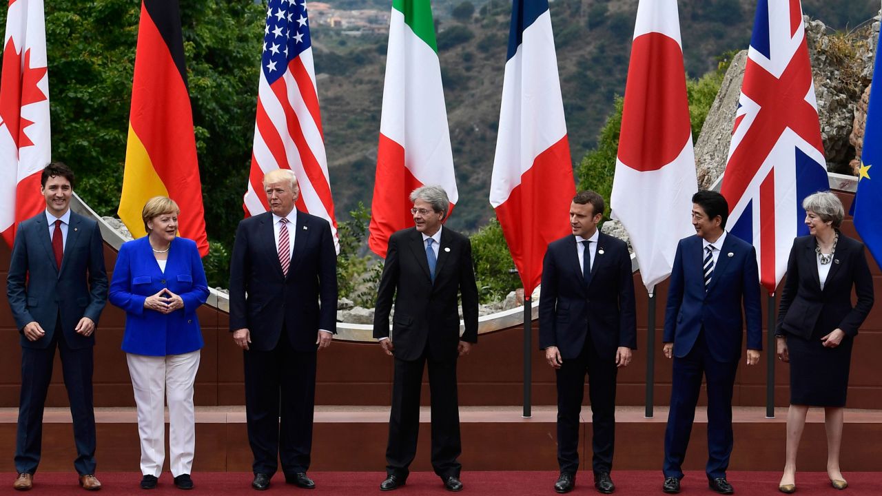 Canadian Prime Minister Justin Trudeau, German Chancellor Angela Merkel, US President Donald Trump, Italian Prime Minister Paolo Gentiloni, French President Emmanuel Macron, Japanese Prime Minister Shinzo Abe, and Britain's Prime Minister Theresa May, pose for a family photo at the ancient Greek Theatre of Taormina during the Heads of State and of Government G7 summit, on May 26, 2017 in Sicily.