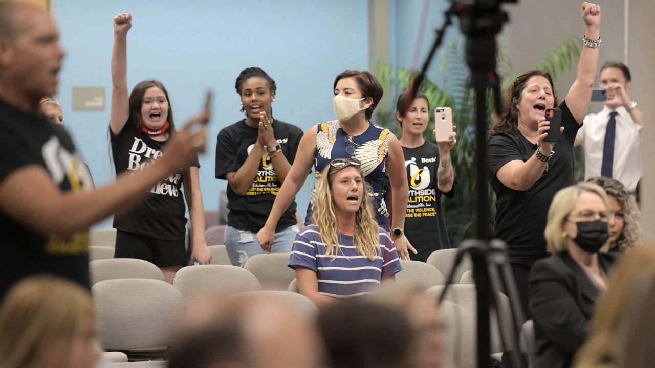 Audience members against the amendment chanted "Allow teachers to teach the truth" during public comments.