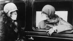 Two women wearing flu masks during a flu epidemic in 1929. (Photo by Keystone/Hulton Archive/Getty Images)
