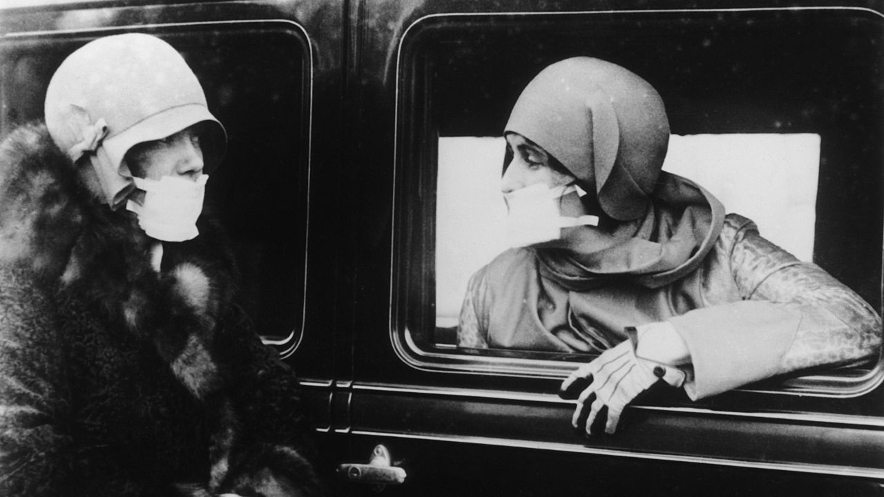 Two women wear masks during an influenza epidemic in 1929, 10 years after the deadly 1918-1919 flu pandemic that took the world by storm.