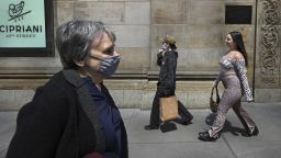 People are seen walking along 42nd Street, some with masks and others without, as The Centers for Disease Control and Prevention eased its guidelines on wearing masks outdoors, saying only fully vaccinated people do not need to cover their faces unless in a large crowd, New York, NY, April 27, 2021. A growing number of people who have received their first dose of vaccine are not going back for their second shot, reducing the efficacy of the vaccine and compromising their immunity to COVID-19. (Photo by Anthony Behar/Sipa USA)(Sipa via AP Images)