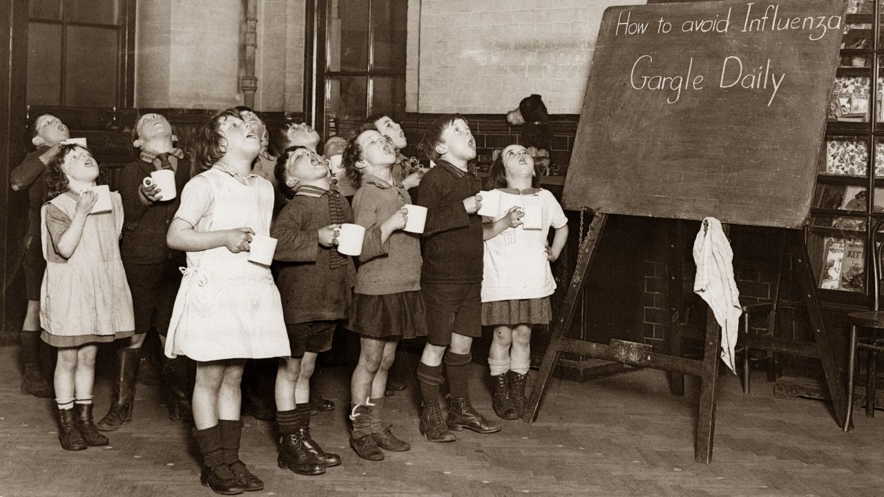 Schoolchildren gargle as a precaution against an influenza epidemic that happened in England sometime around 1935.