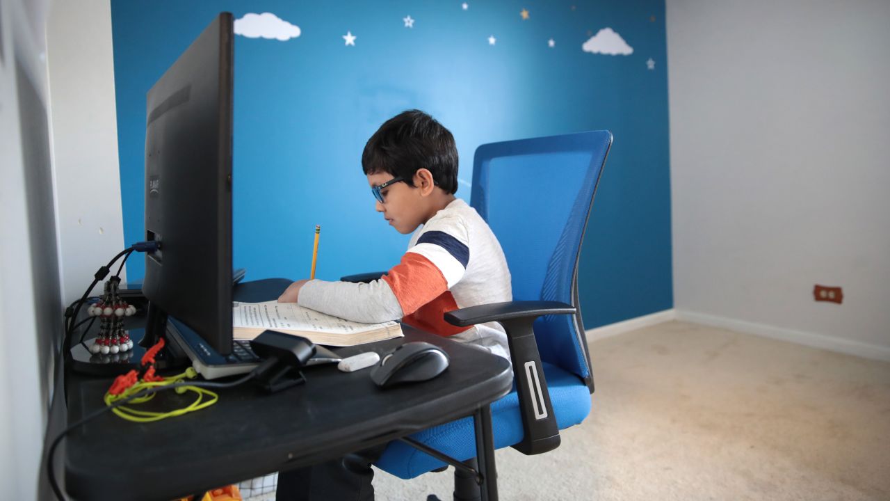 Hamza Haqqani, a then-second grader at Al-Huda Academy, participates in an e-learning class while at his home in Illinois on May 1, 2020.