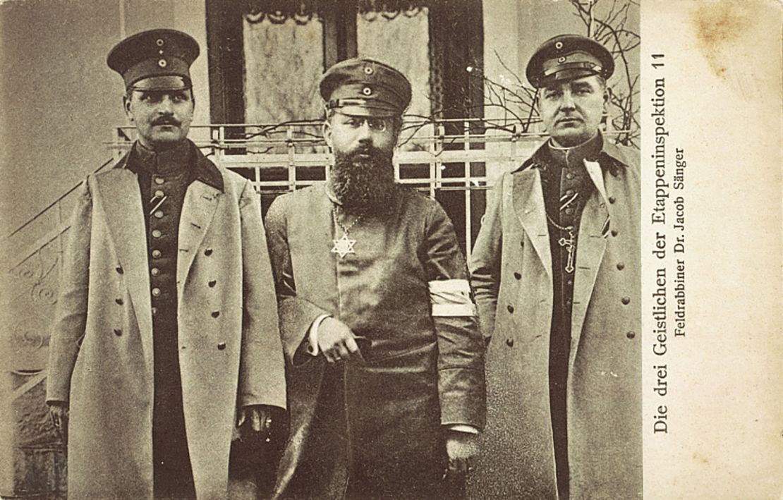 This photo postcard, issued around 1915 to 1916, shows military Jewish chaplain Dr. Jacob Sänger (middle). A Catholic and Protestant clergyman stand either side.  